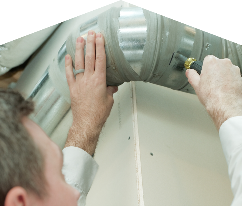 M&K HVAC technician inspecting and tightening a joint on a sealed metal air duct, performing maintenance work during an air duct cleaning task. M&K HVAC technician inspecting and tightening a joint on a sealed metal air duct, performing maintenance work during an air duct cleaning task.