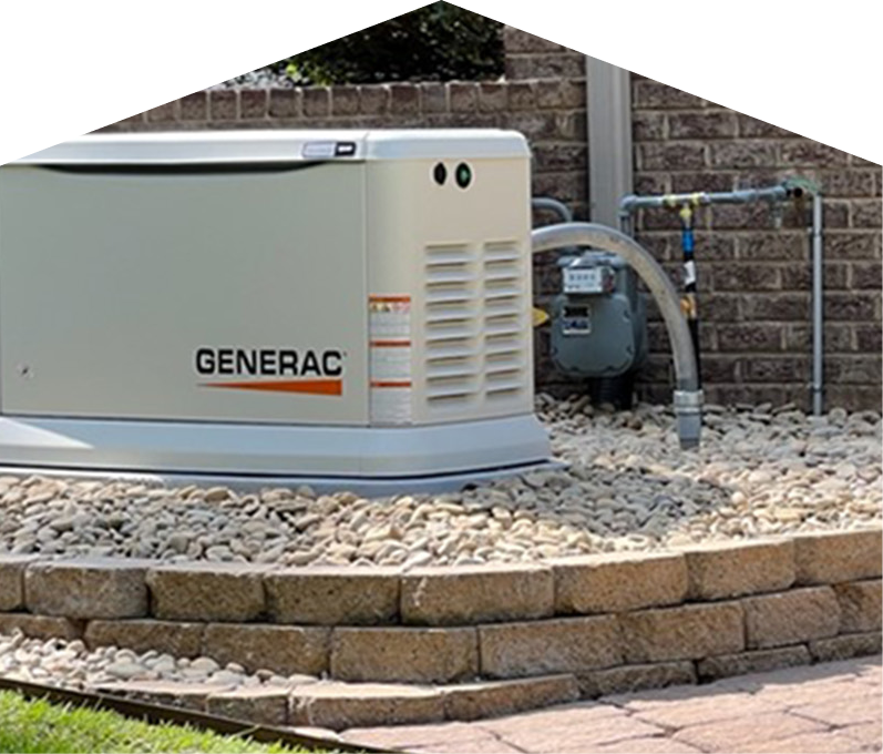Generac standby generator installed by M&K on a raised stone platform beside a brick wall, connected to a natural gas meter for backup power supply.