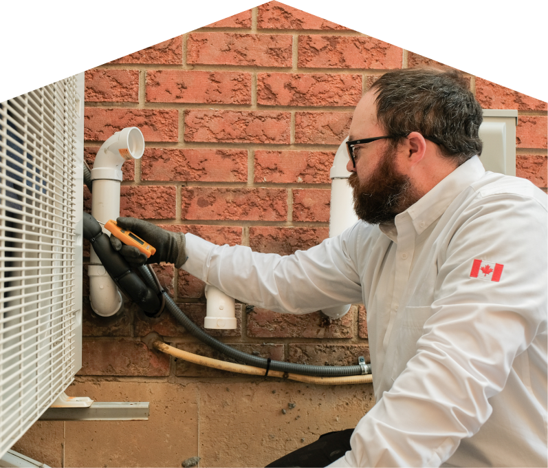 M&K HVAC specialist checking insulated piping on a heat pump unit beside a brick wall during a diagnostic service. M&K HVAC specialist checking insulated piping on a heat pump unit beside a brick wall during a diagnostic service.