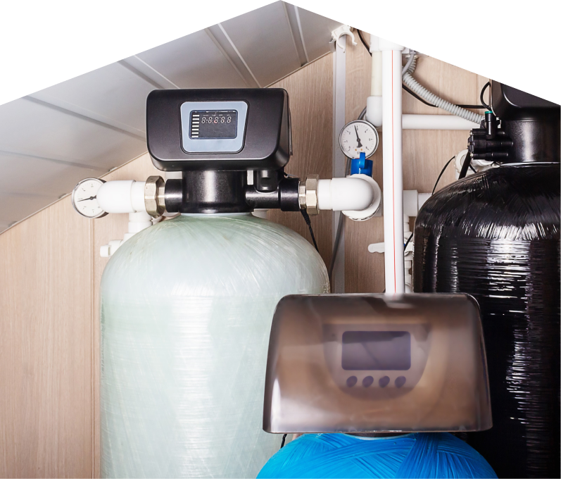 M&K home water filtration system featuring resin tanks, digital control heads, pressure gauges, and connected piping in a utility room. M&K home water filtration system featuring resin tanks, digital control heads, pressure gauges, and connected piping in a utility room.