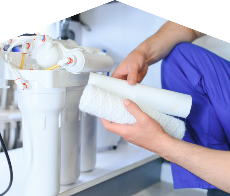M&K water filtration specialist replacing filter cartridges on a reverse osmosis water system installed under a sink. M&K water filtration specialist replacing filter cartridges on a reverse osmosis water system installed under a sink.