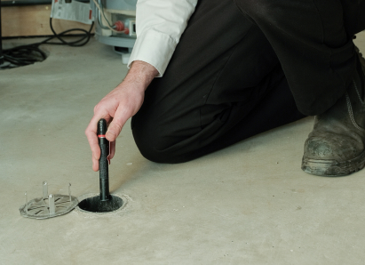 M&K service personnel inserting a diagnostic tool into a floor drain for a residential drain and sewer service check. M&K service personnel inserting a diagnostic tool into a floor drain for a residential drain and sewer service check.
