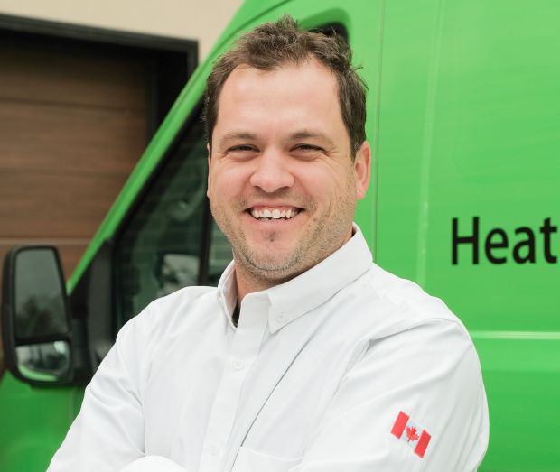 Smiling M&K technician standing confidently in front of their green service van, wearing their white issued uniform. Smiling M&K technician standing confidently in front of their green service van, wearing their white issued uniform.