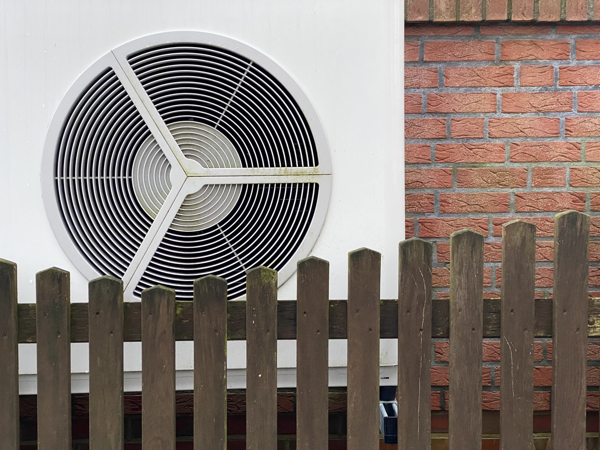 Heat pump in front of house facade Heat pump in front of house facade