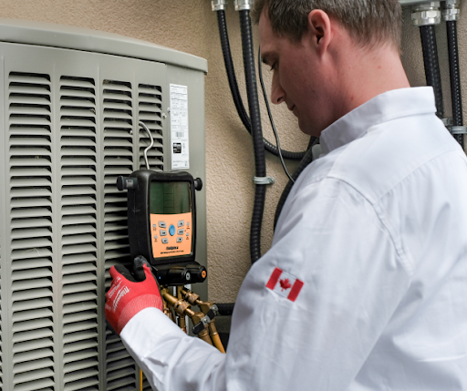 M&K Heating and Air Conditioning technician diagnosing refrigerant pressure on an outdoor AC condenser during an emergency service call.